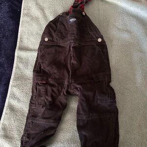 OshKosh B'gosh black corduroy overalls with red plaid accents